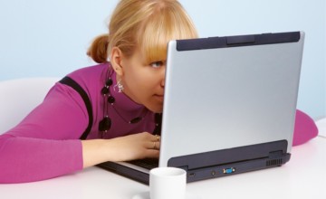 Photo d'une femme regardant son ordinateur de trop près au travail